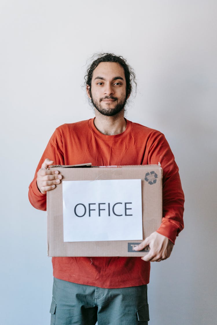 Man Carrying A Box Of Office Materials