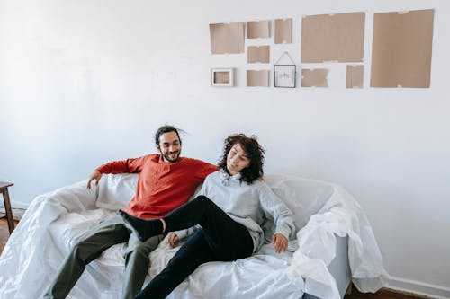 A Couple Relaxing On A Sofa