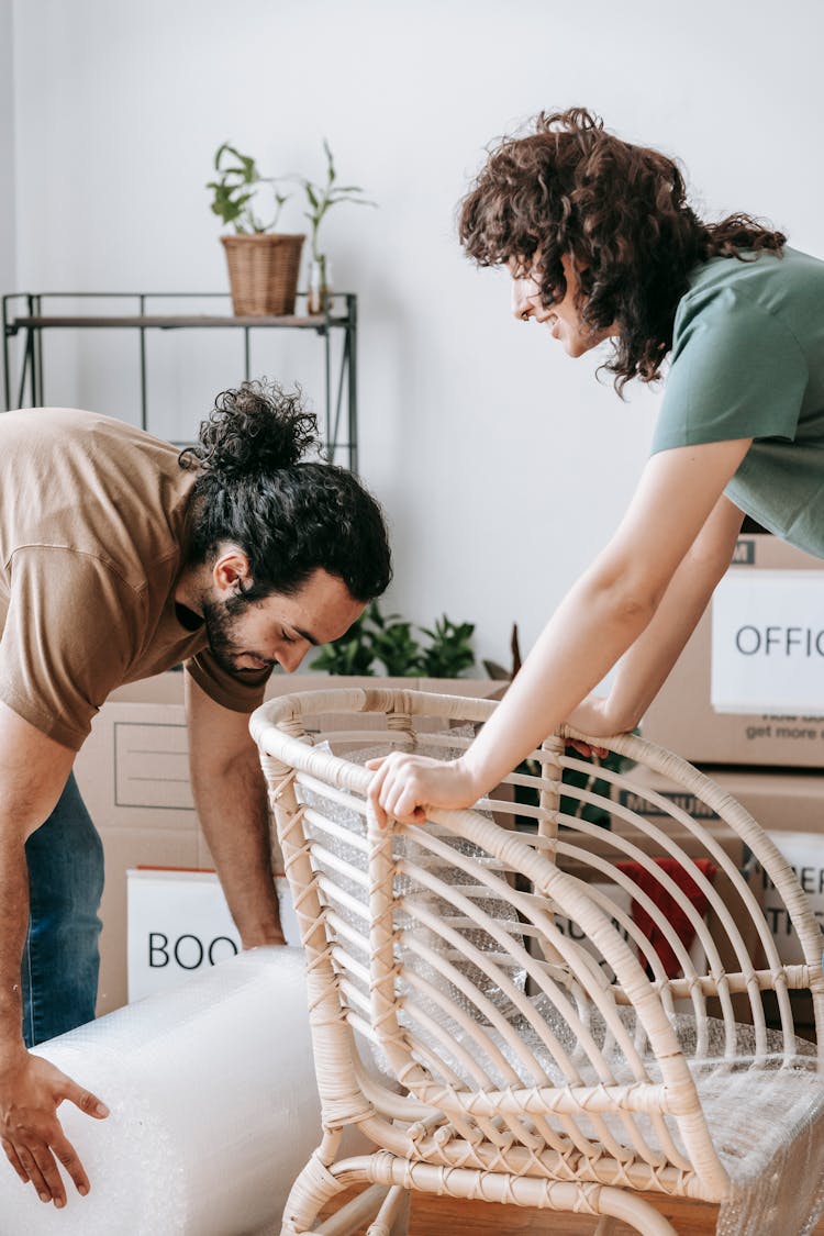 A Couple Packing Things In Boxes