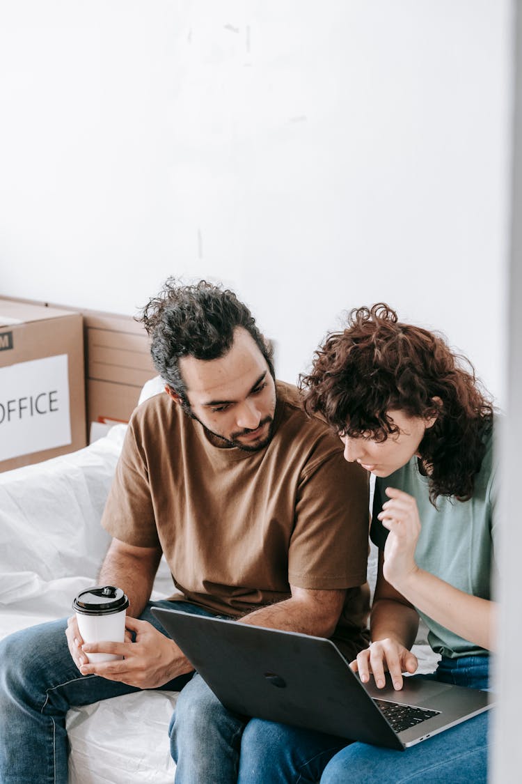 Couple Looking On A Laptop Computer