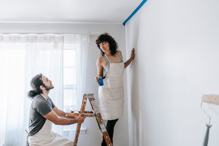 Couple Painting The Wall 