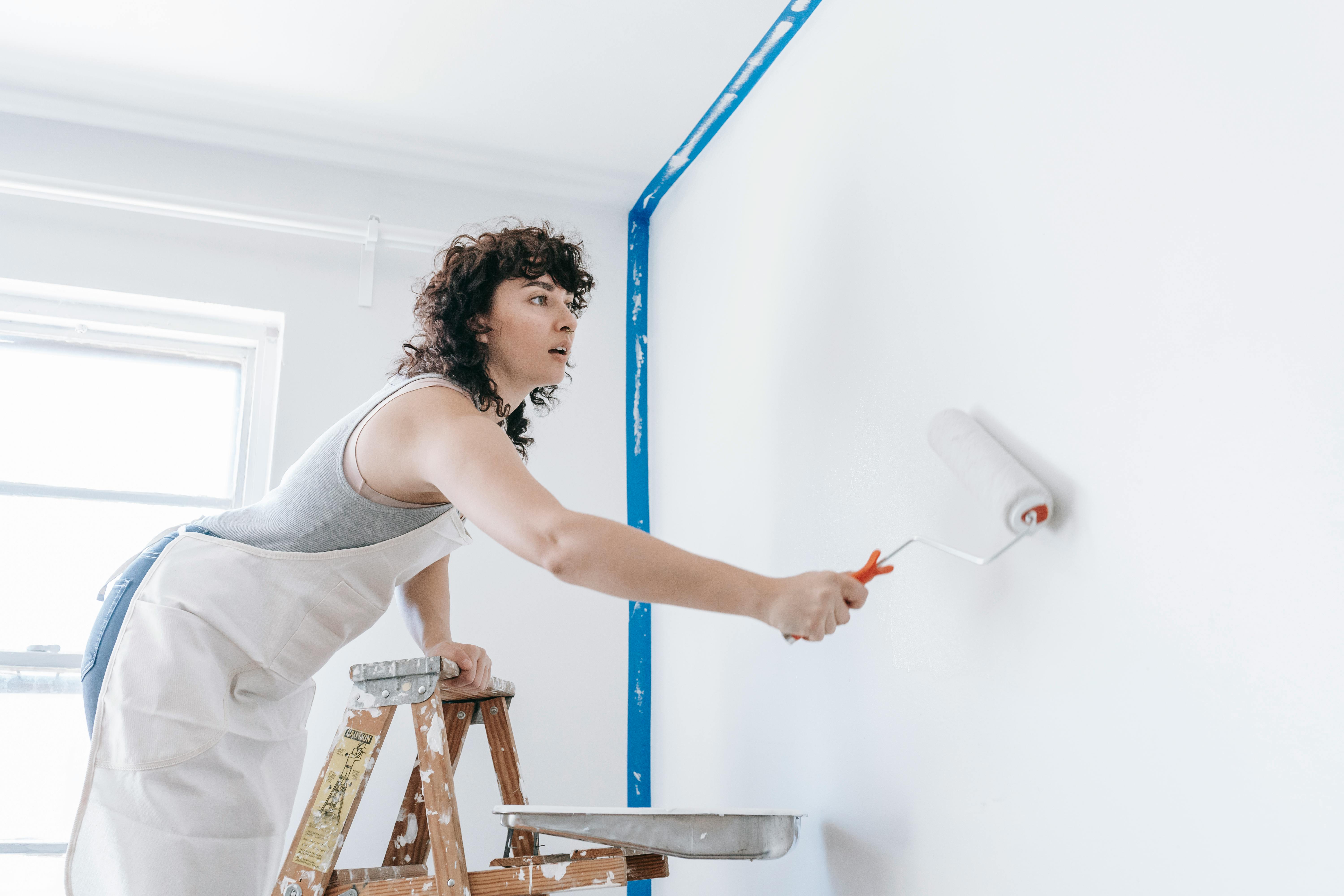 woman painting wall        
        <figure class=