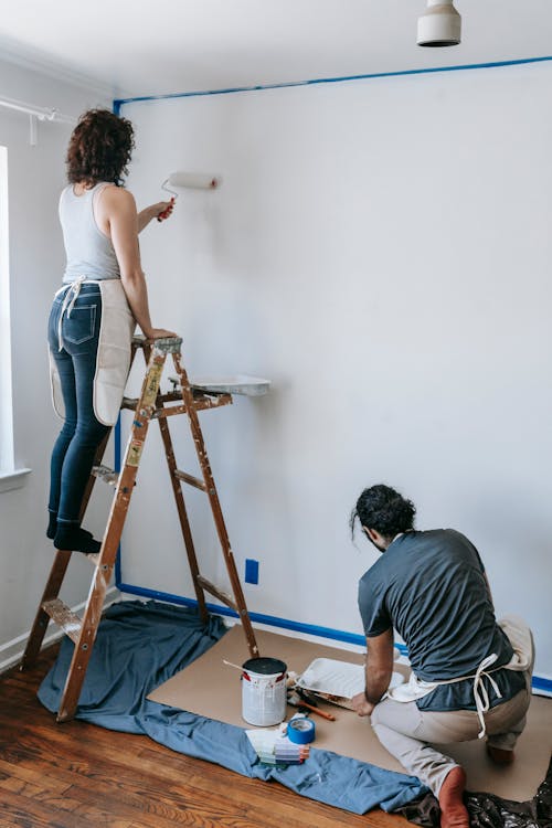 Couple Painting The Wall White