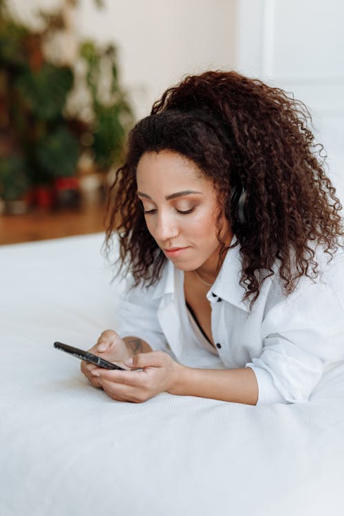 Woman Wearing Headphones Using a Cellphone