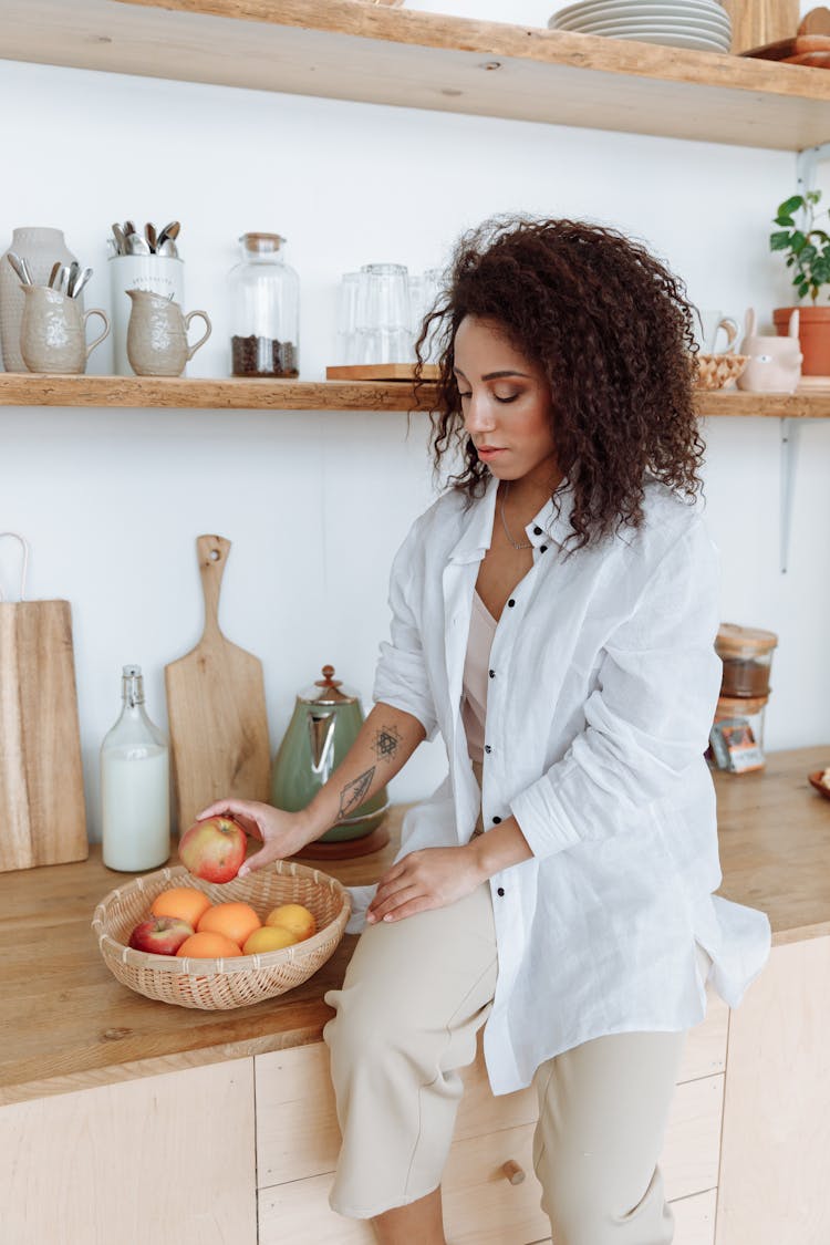 Woman In A White Shirt Holding An Apple