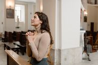 Woman in Brown Tank Top and Blue Denim Jeans Sitting on Brown Wooden Chair