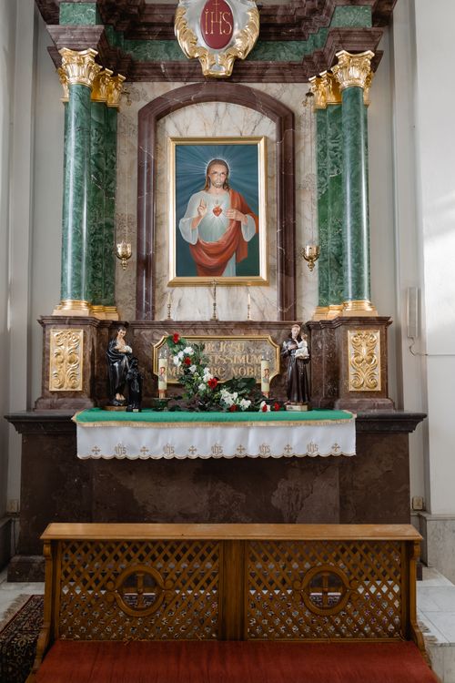 Free Beautiful church altar featuring the Sacred Heart of Jesus surrounded by religious artifacts. Stock Photo