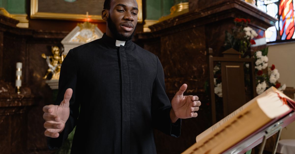 close-up of a pastor preaching passionately with congregation in background