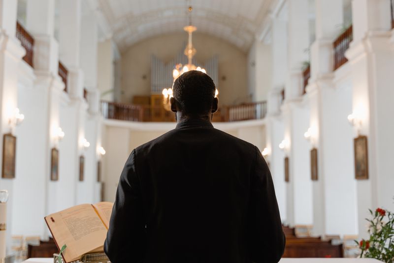 Portrait of African American senior pastor in suit/robe
