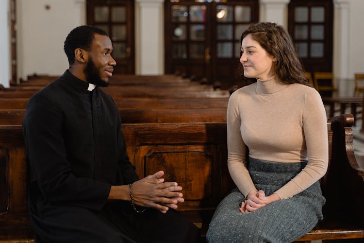 A Woman And A Priest Talking