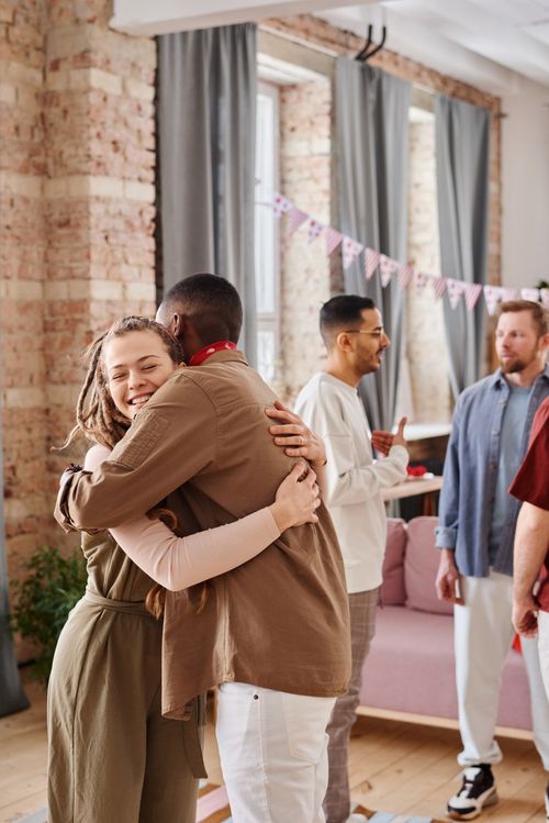 Free A diverse group of friends celebrating indoors with excitement and togetherness. Stock Photo