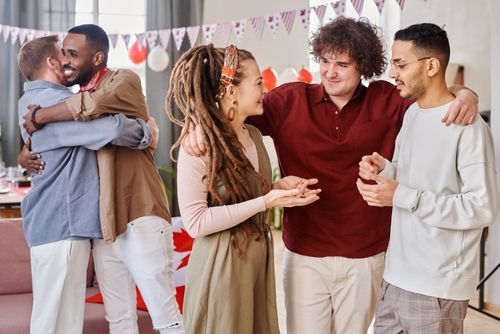 Free A diverse group of friends enjoying a joyful indoor gathering with decorations. Stock Photo