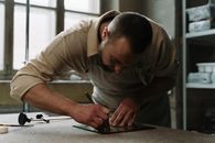 A Man Cutting a Glass