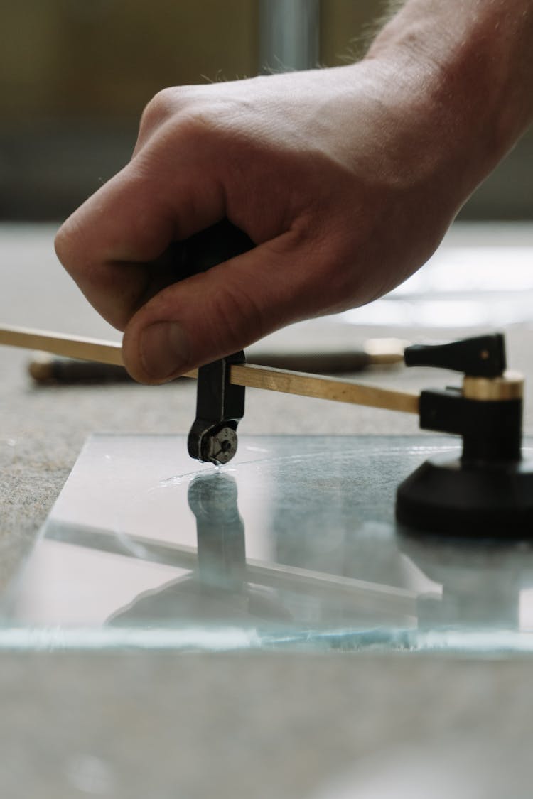 A Person Glass Cutting