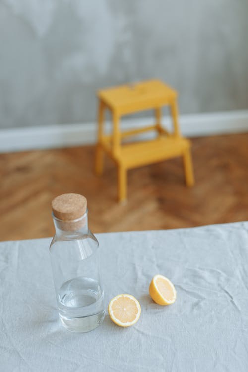 Free Photo of a Glass Bottle Near a Sliced Lemon Stock Photo