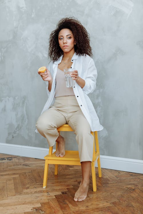 Free Photo of a Woman Holding a Glass and a Slice of Lemon Stock Photo