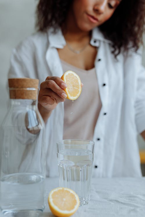 A Woman Squeezing a Lemon