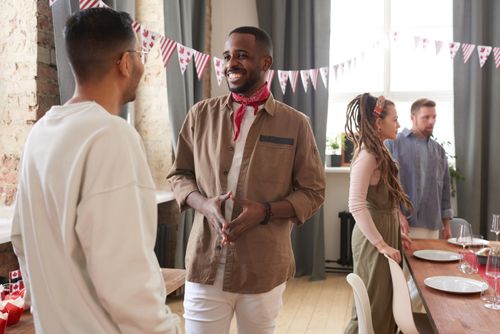 Free Diverse group of adults celebrating indoors during a festive occasion with decorations. Stock Photo