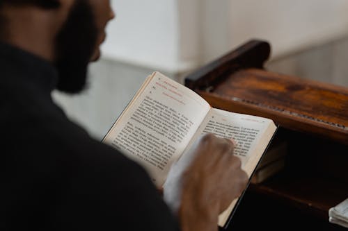Free Man in Black Robe Reading the Holy Bible Stock Photo