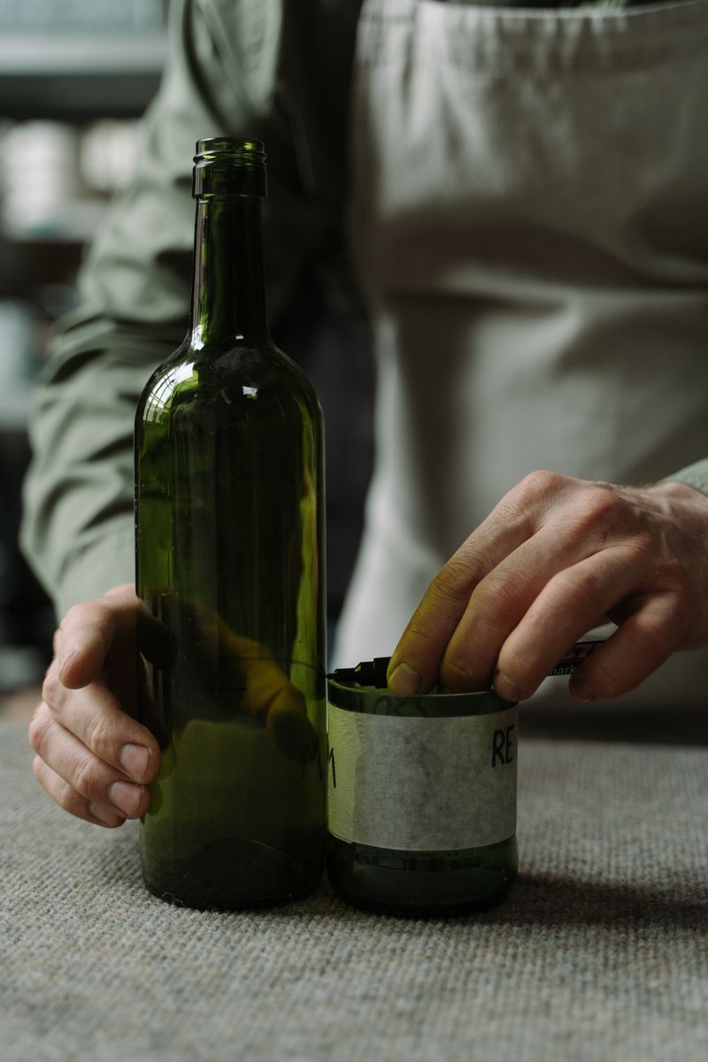A craftsman transforms glass bottles into art using sustainable techniques.