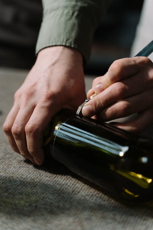 A Close-Up Shot of a Person Cutting a Wine Glass