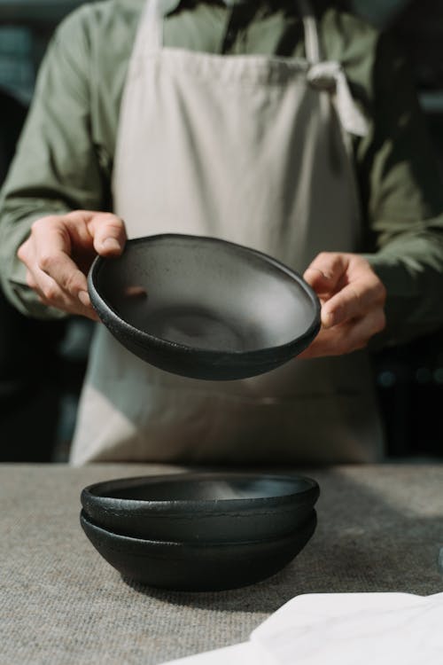 A Person in an Apron Holding a Bowl