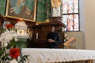 A Man Standing in Front of the Church Altar