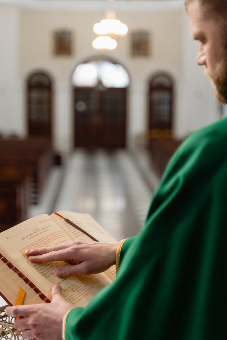 A Person Holding A Bible