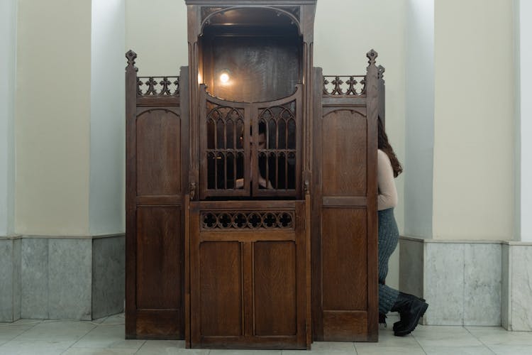 A Person Inside A Confessional