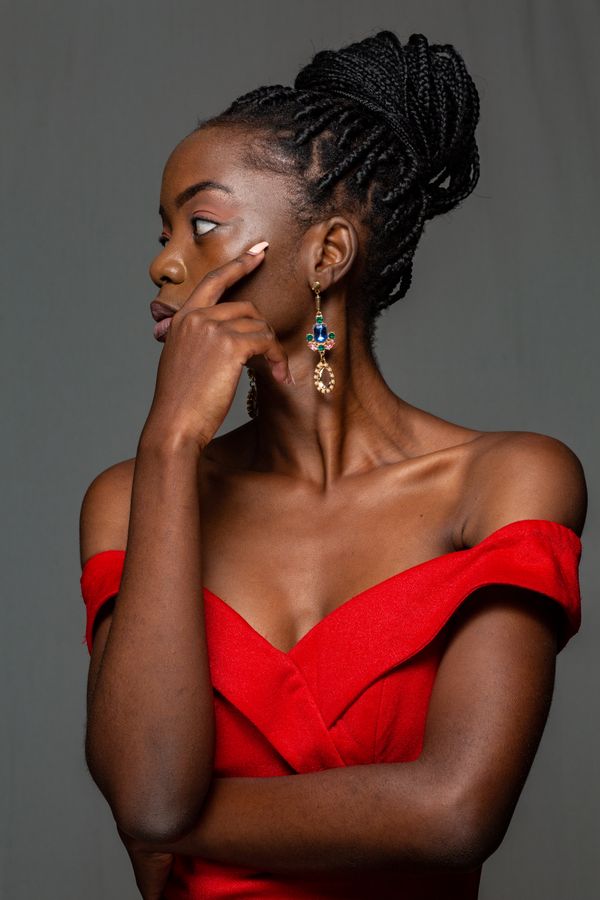 Woman in an off-shoulder sweater dress with statement earrings