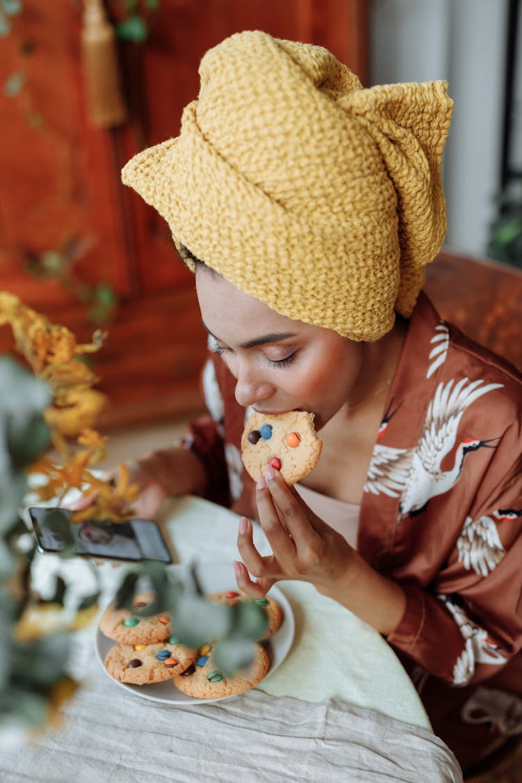 Woman In Head Towel Eating Cookie