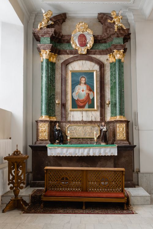 Free A beautifully ornate altar with religious symbols and art inside a church. Stock Photo