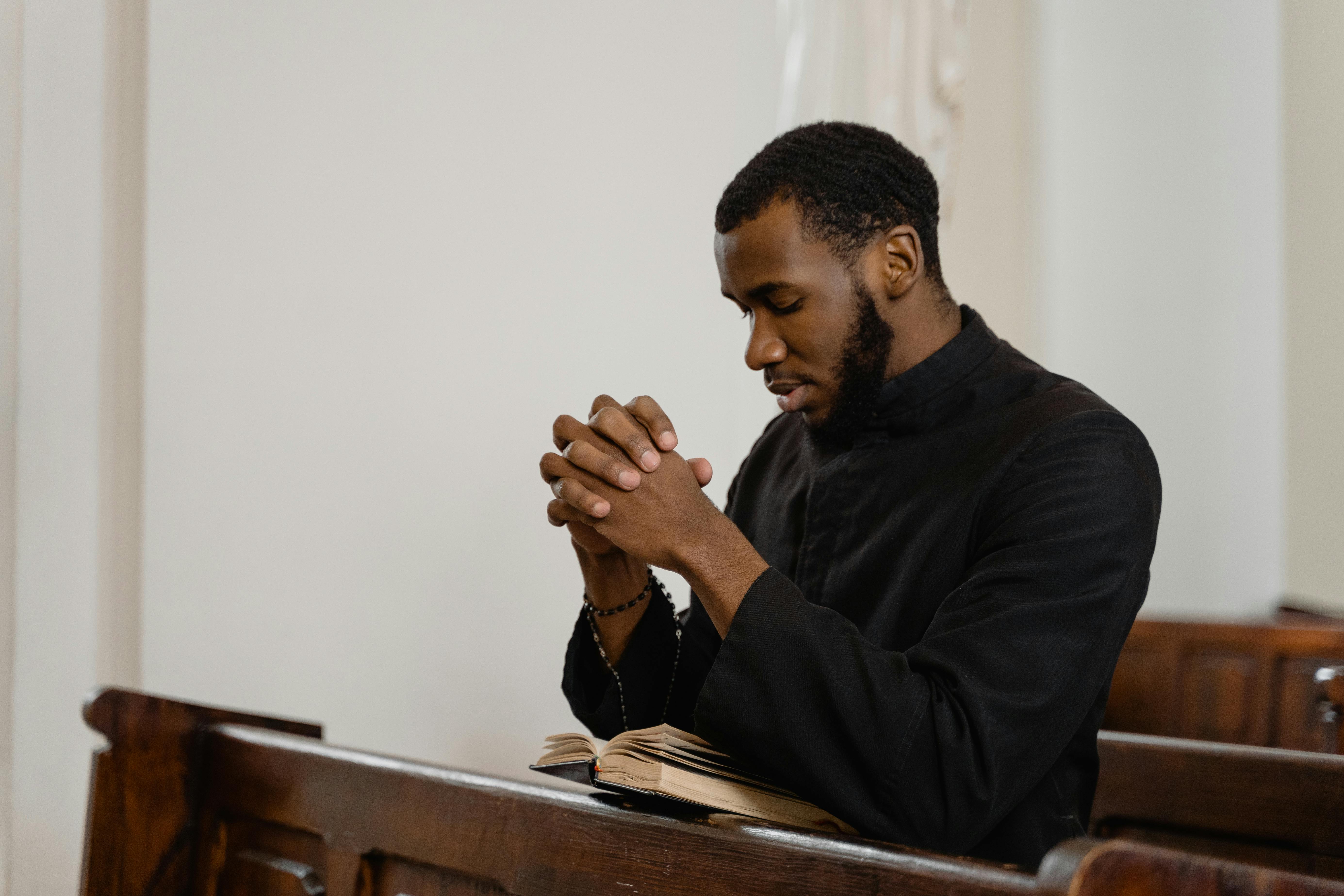 a religious man praying solemnly