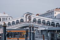 Unrecognizable people on Rialto Bridge against buildings in city