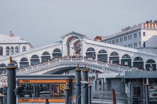 Unrecognizable people on Rialto Bridge against buildings in city