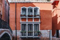 Aged house facade with balconies in city