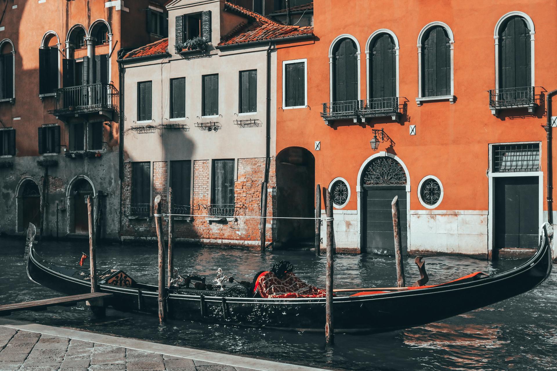 A classic gondola on Venice's canal against colorful historic architecture, capturing the essence of traditional Italian scenery.