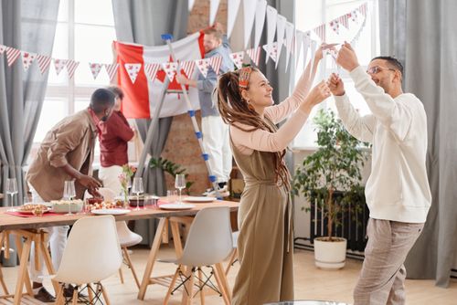 Free Young adults enjoying a festive indoor party with decorations and celebration vibes. Stock Photo