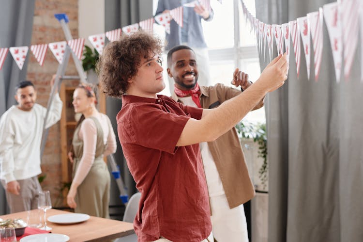 
Men Hanging Decorations For A Party