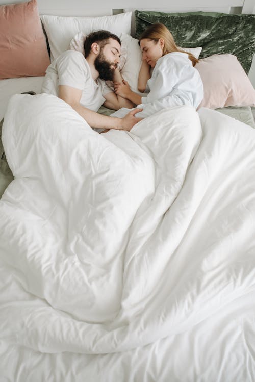 Free 
A Couple Sleeping in the Bed Stock Photo