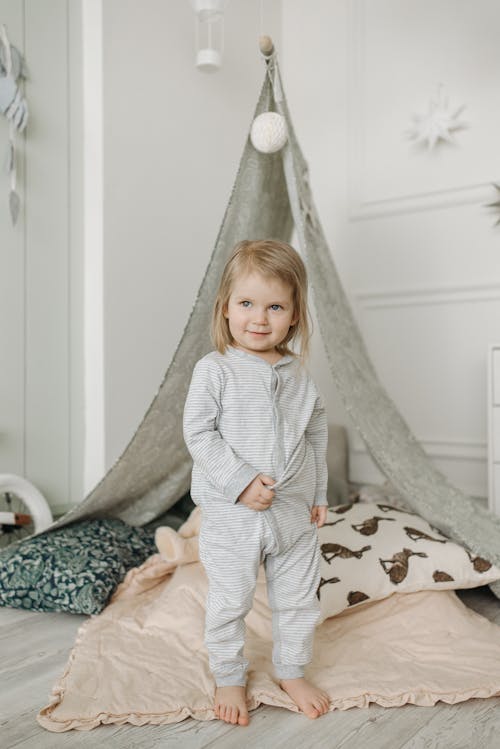 Free Little Blonde Girl in Front of a Tent in Bedroom  Stock Photo