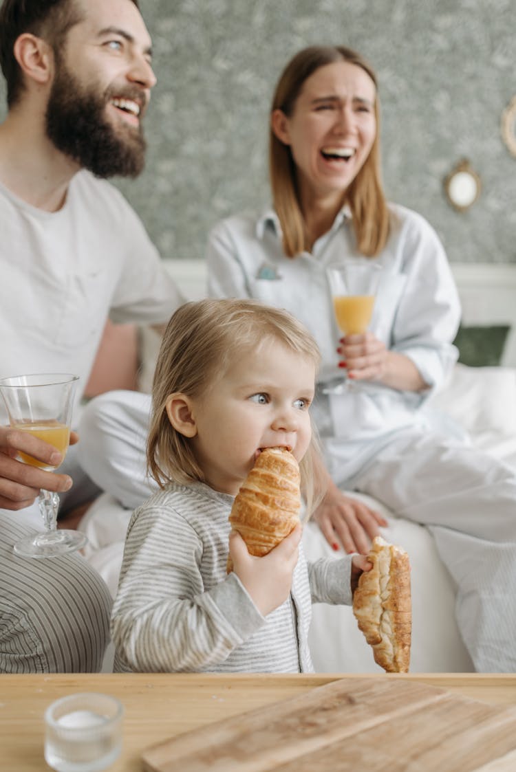 Photo Of A Child Eating A Croissant