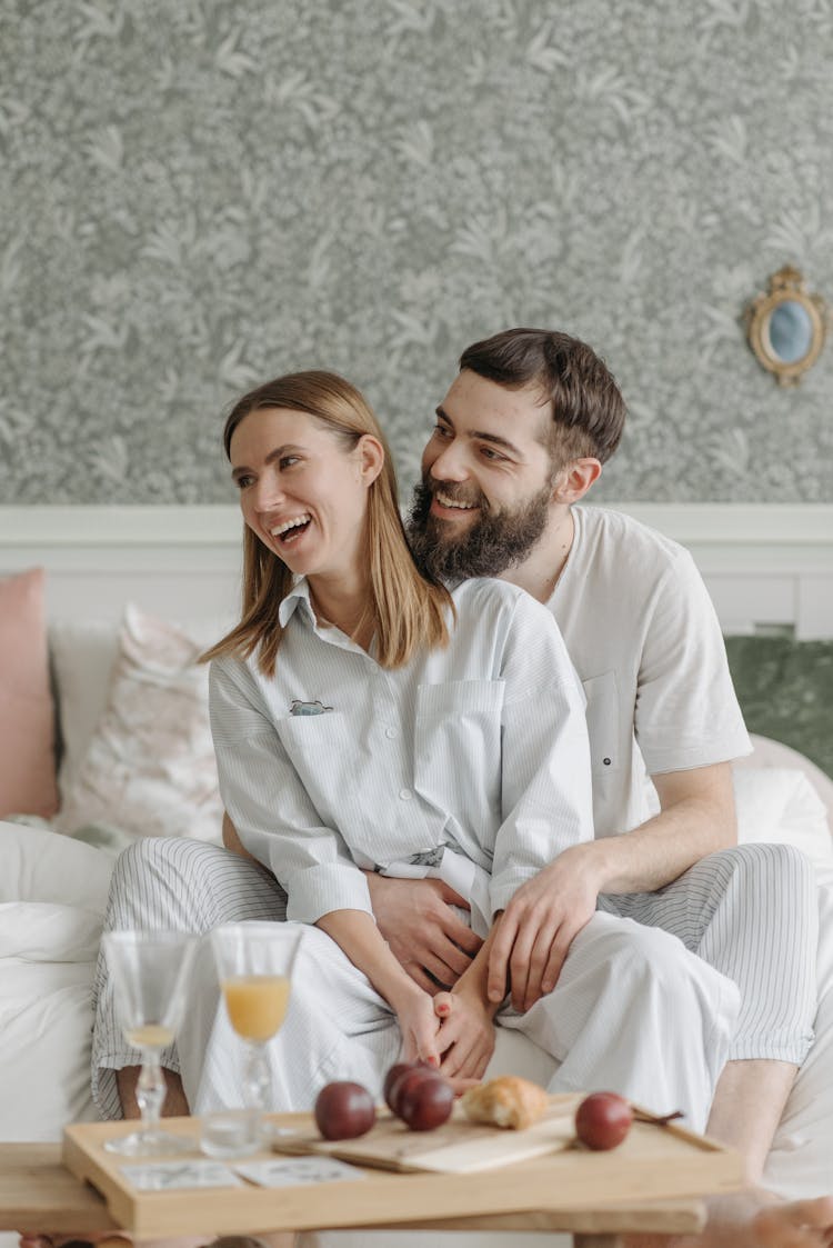 Laughing Couple Sitting On A Couch