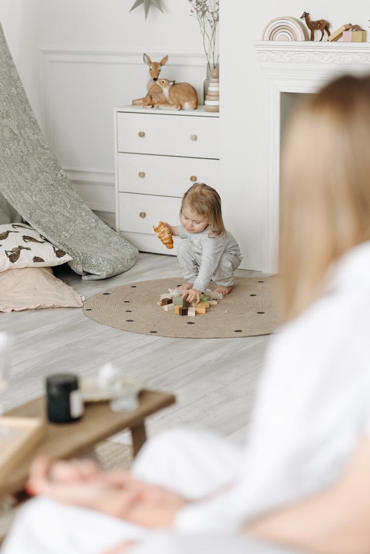 A Girl Picking Up Her Toys