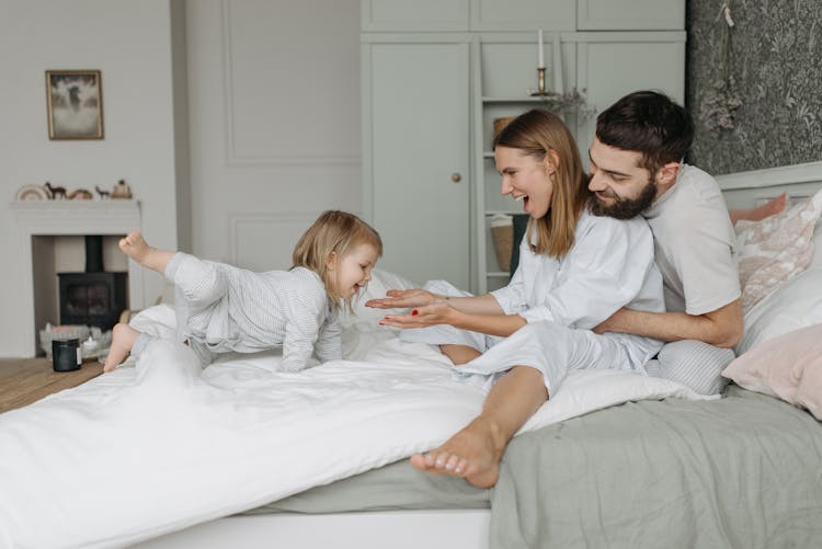 Happy Family On The Bed