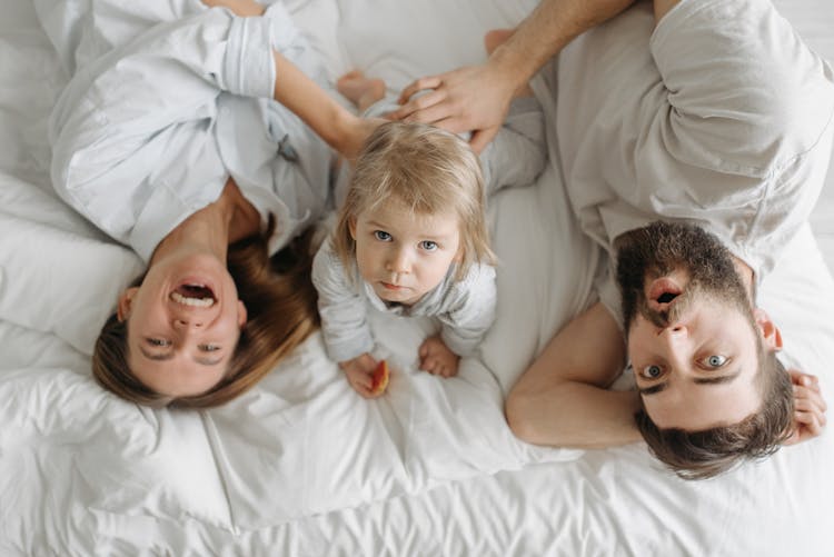 High-Angle Shot Of A Happy Family On The Bed