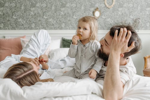 Close-Up Shot of a Happy Family on the Bed