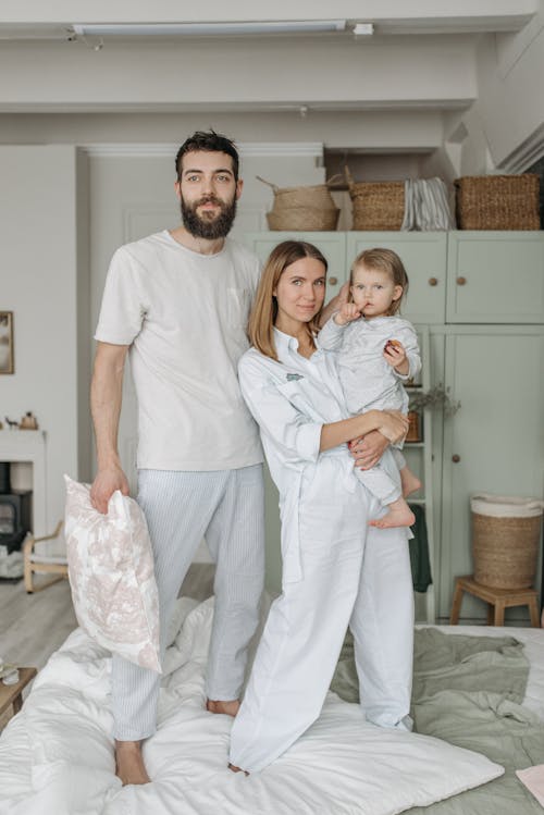 Free Happy Family Standing on Bed Stock Photo