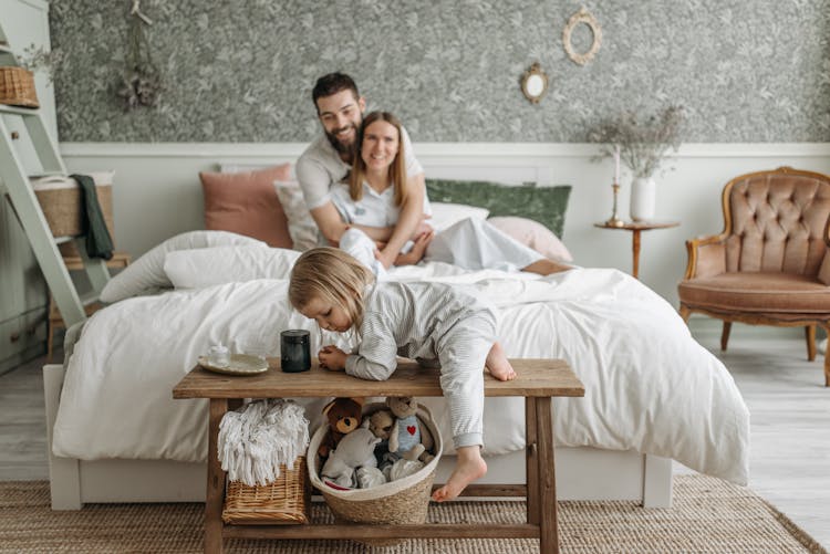 Happy Family In The Bedroom