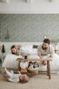 Man and Woman Sitting on White Couch